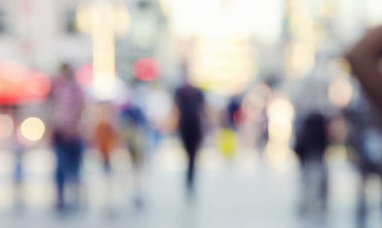a crowded street with people walking